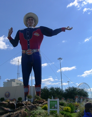 [Large statue of a man in Dickies clothing, boots, and a 10 gallon hat.]